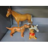 A Beswick model of a Palomino standing stallion horse model and a Winnie the Pooh figurine, along