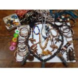 Bead, shell and treen costume jewellery to include bangles, modern earrings and African treen