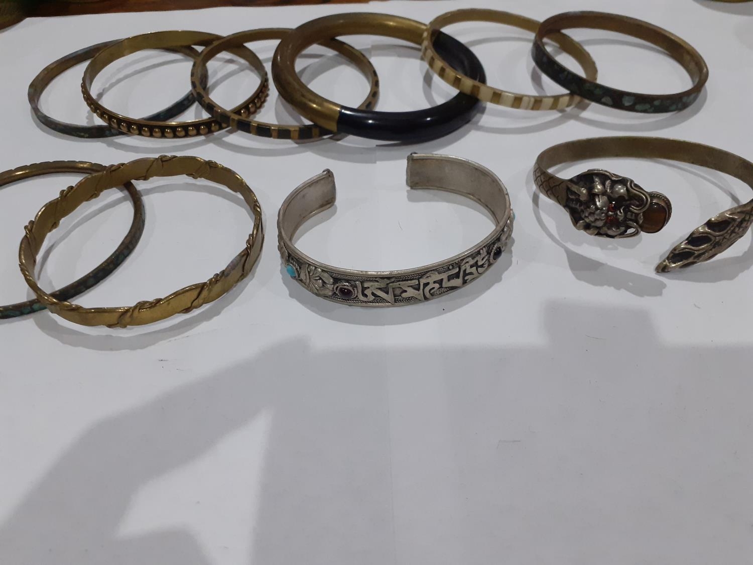 Eastern white metal and silver and other metallic bangles to include ornate bangles with snake, - Image 6 of 12