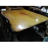 An early Victorian mahogany breakfast table having turned central column and on four carved