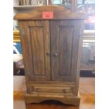 A modern oak chest fashioned as a miniature wardrobe, with twin doors, enclosing five drawers