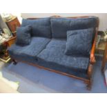 A late 20th century mahogany framed Frank Hudson Bergere sofa having scrolled arms and the front