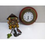 A 20th century painted, carved wooden cased cuckoo clock and a modern quartz marine clock