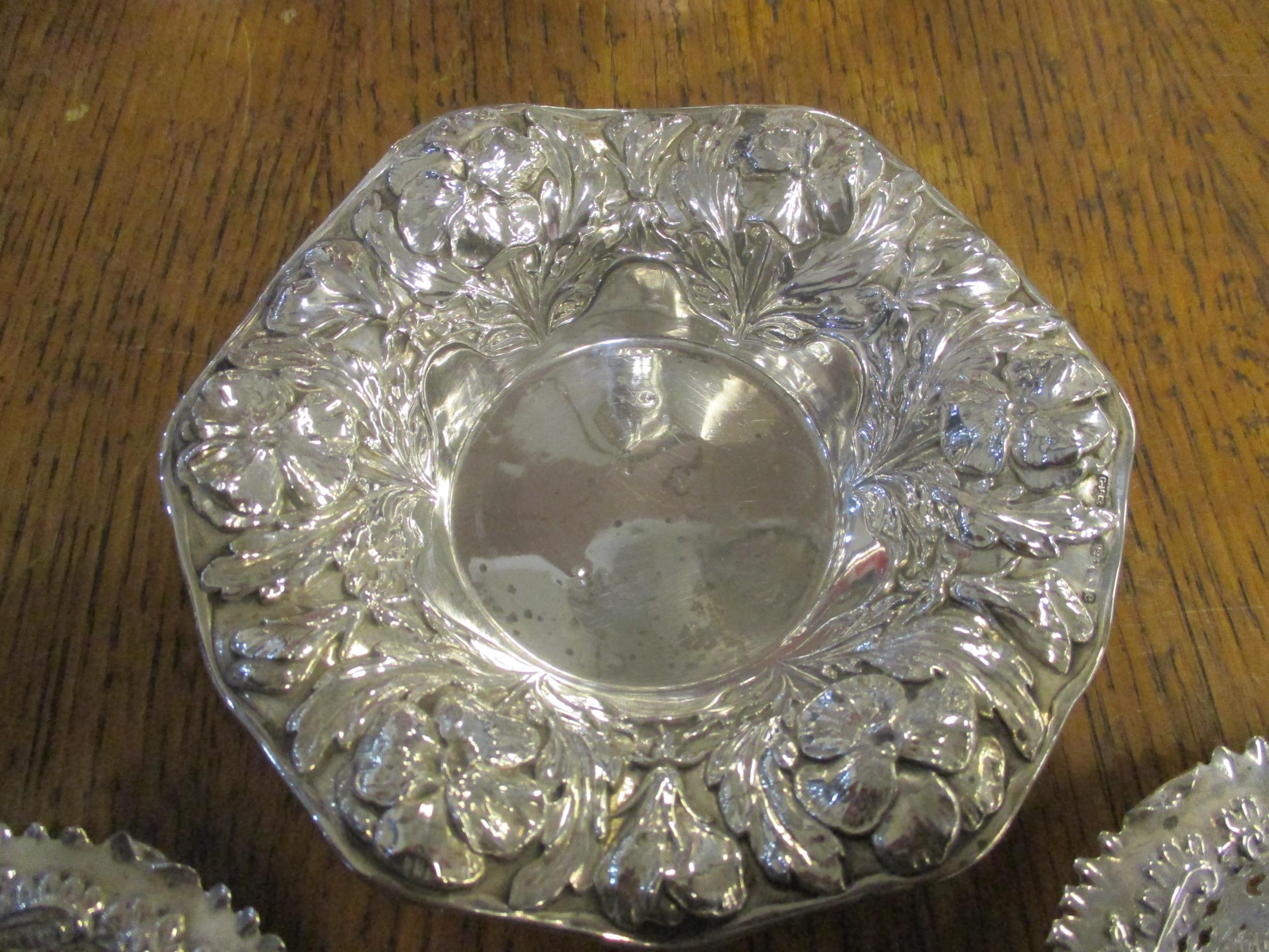 A 925 silver dish of octagonal form, repousse decorated with flower heads and leaves and a pair of - Image 2 of 3