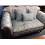 A Medallion blue striped two seater sofa with scrolled show wood
