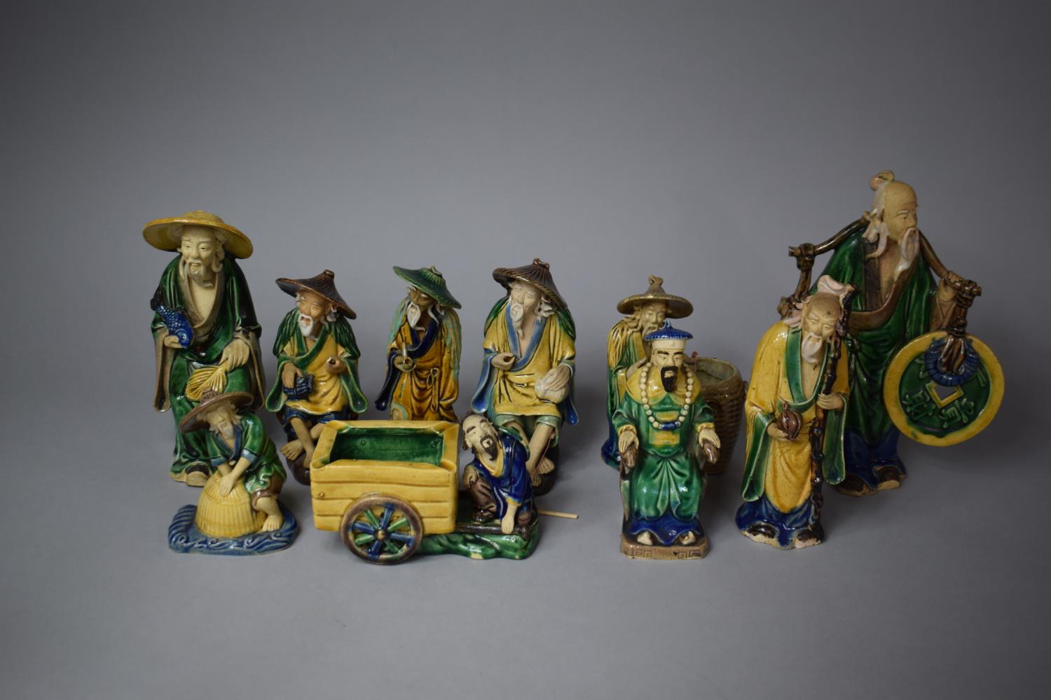 A Collection of Various Sanci Glazed Mud Men, Tallest 24cm High, Eight in Total