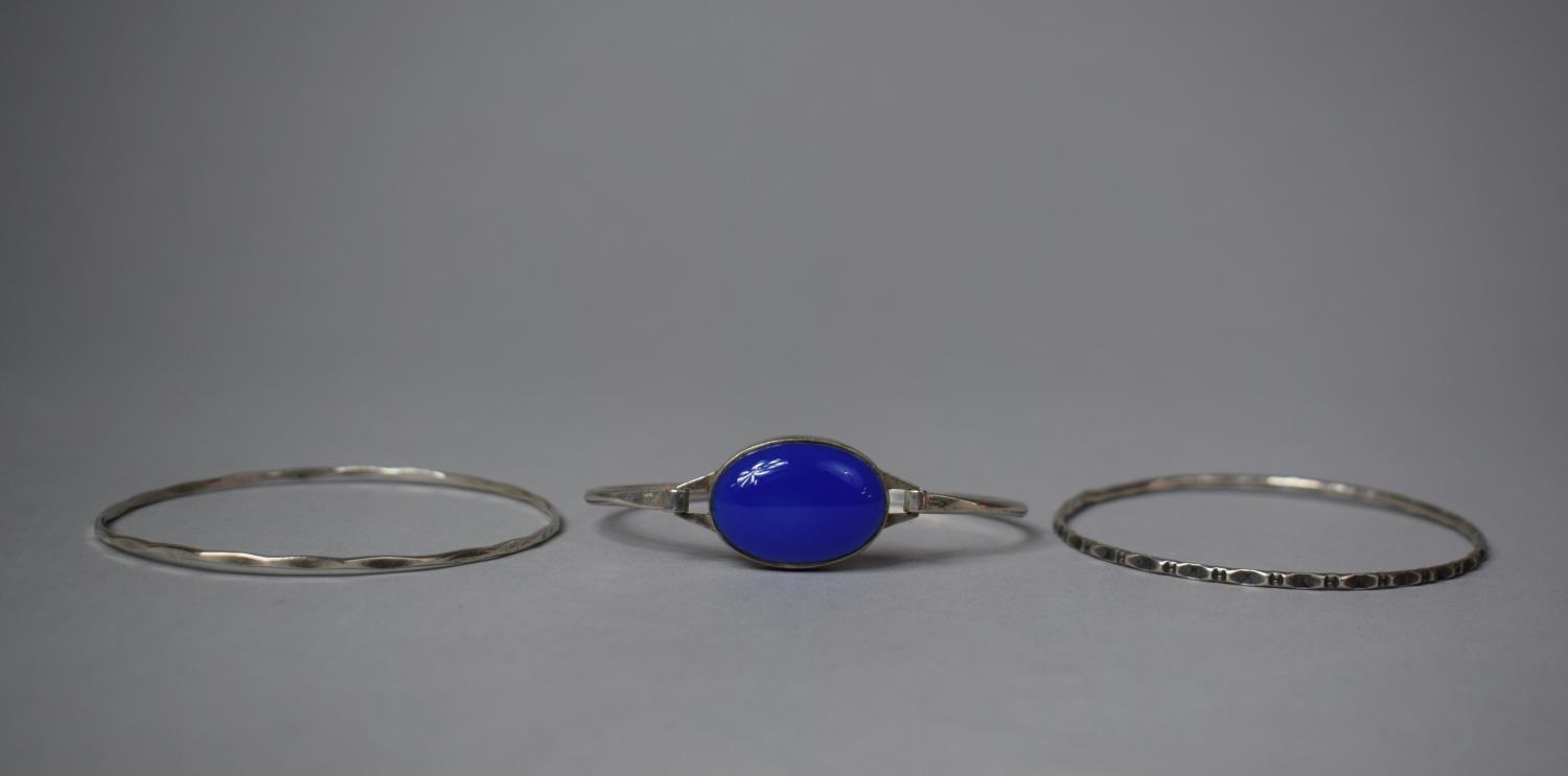 A Silver Bracelet with Oval Blue Cabochon Together with Two Other Bangles