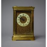 A Late 19th Century Brass Carriage Clock with Gilt Metal Face Panel Decorated in Relief with