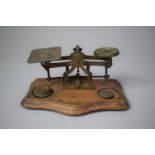 A Late 19th/Early 20th Century Set of Brass Postage Scales Set on Serpentine Fronted Wooden Stand