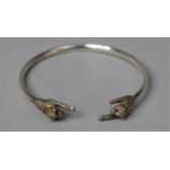 A Silver Bangle with Double Leaping Leopard Terminals Both Having Ruby Eyes, 6cm Circumference
