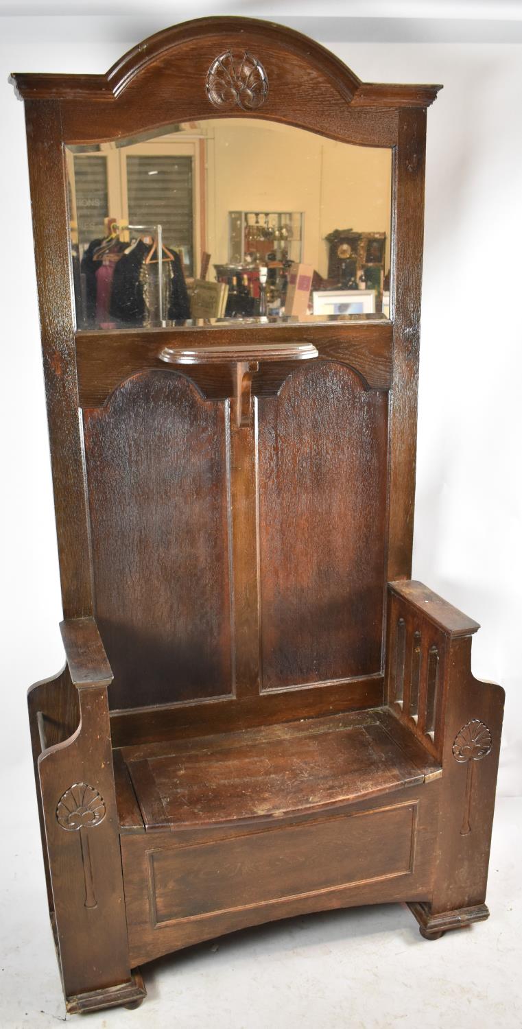 An Edwardian Oak Hall Stand with Shaped Mirror Above Small Shelf, Central Hinged Seat Store