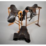 Three Vintage Leather Saddles to include Examples by Barnsby and Son and Moss Bros Saddlers Etc