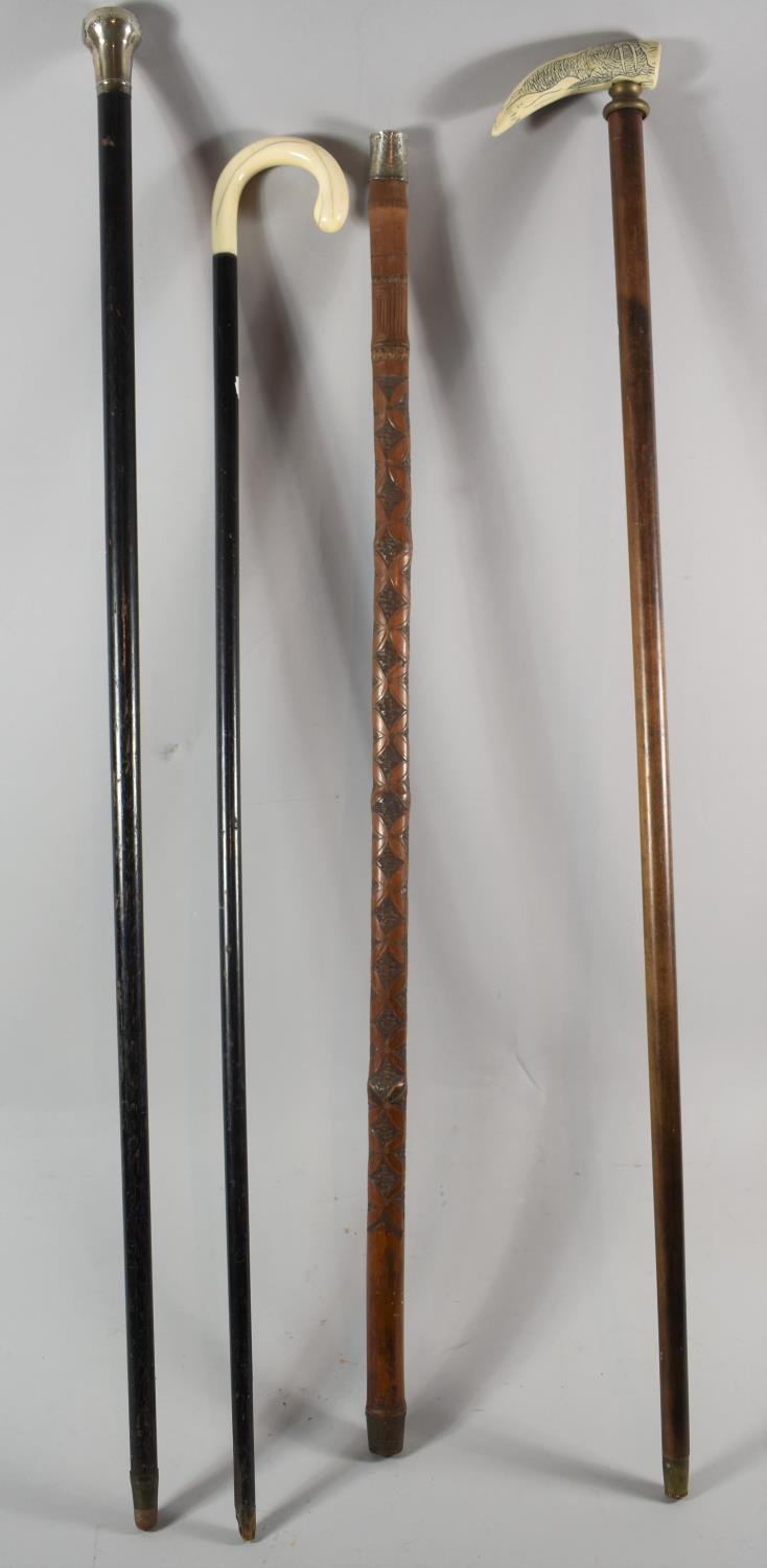 A Collection of Four Walking Sticks to Include Ebonized and Silver Mounted Example (Top AF) Marine