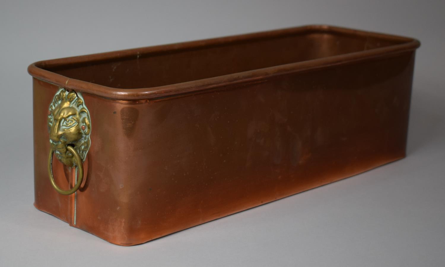 A Rectangular Copper Planter Having Lipped Edge and Brass Lion Mask Loop Handles, 42cms Wide