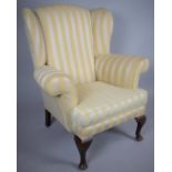 An Upholstered Wing Armchair