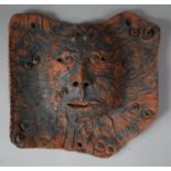 A Terracotta Plaque with Green Man Decoration, 25cms Wide