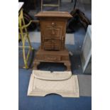 A Belgian/French Brown Enamelled Cast Iron Stove with Losses