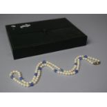 A String of Pearls and Blue Glass Beads having Silver Clasp Stamped 935