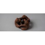 A Carved Wooden Netsuke in the Form of Three Entwined Monkeys, Signed to Base