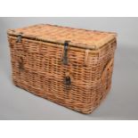 A Large Wicker Hamper with Leather Straps and Two Carrying Handles to Sides