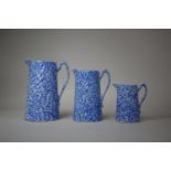 A Graduated Set of Three Glazed Mottled Blue and White Jugs, Tallest 20cm high