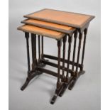 A Nest of Three Mahogany Framed Tables with Tooled Leather Tops, 49cm wide