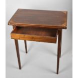 An Edwardian String Inlaid Mahogany Rectangular Games Table with Hinged Envelope Top and Beize