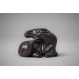 A Carved Horn Netsuke in the Form of a Reclining Horse, 5cm Long