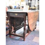 A 19th Century Oval Topped Drop Leaf Oak Gate Legged Dining Table with Single Drawer, 125cm Long