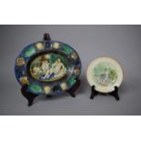 A Continental Majolica Oval Bowl Decorated in Relief with Cherubs Attending Maiden Together with a