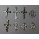 A Collection of Eight Silver Crucifix and St. Christopher Pendants