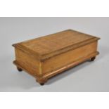 An Edwardian Lift Top Oak Musical Jewellery Box of Sarcophagus Form, 25cm wide (working Order)