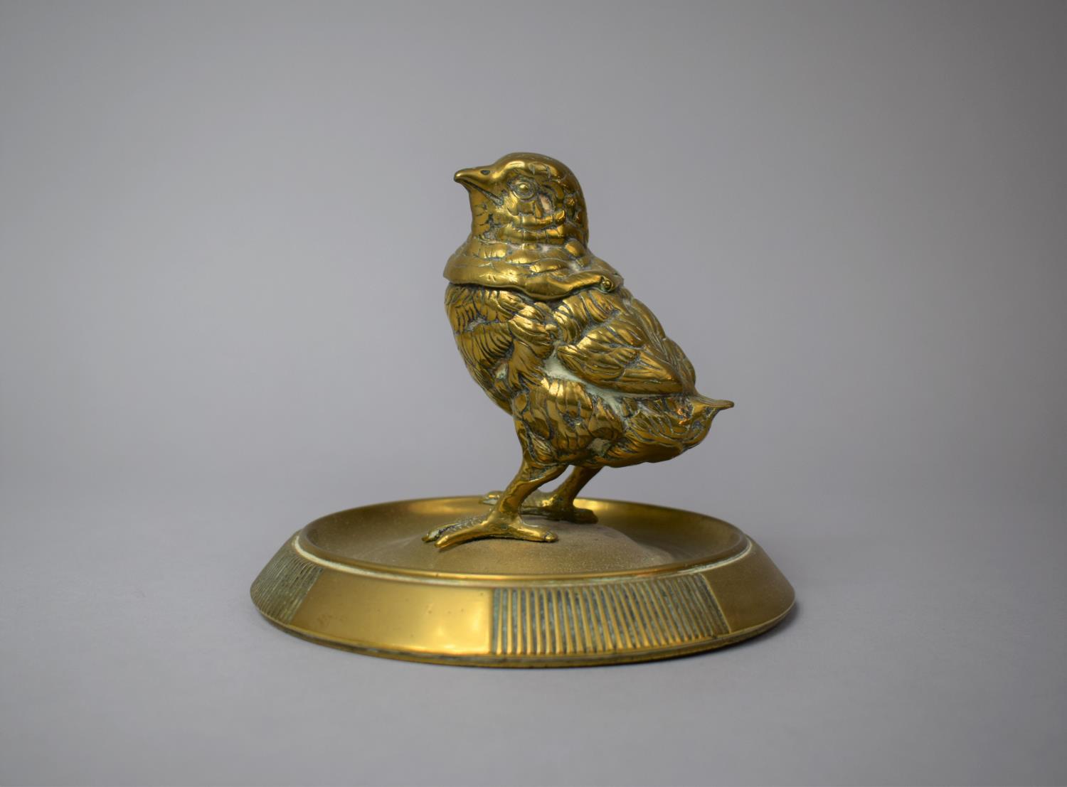 A Late 19th/Early 20th Century Novelty Brass Desktop Inkwell in the Form of a Chick, Circular Plinth