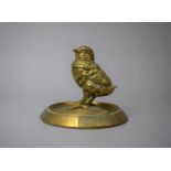 A Late 19th/Early 20th Century Novelty Brass Desktop Inkwell in the Form of a Chick, Circular Plinth