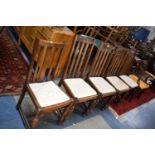 A Set of Four Plus One Edwardian Oak Dining Chairs