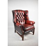 A Buttoned Red Leather Wing Armchair