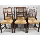 A Harlequin Set of Six Spindle Back Rush Seated Dining Chairs