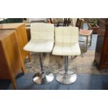 A Pair of Chrome Based Adjustable Leather Effect Bar Stools