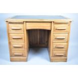 An Edwardian Oak Kneehole Writing Desk with Two Slides, Centre Drawer and Four Short Drawers