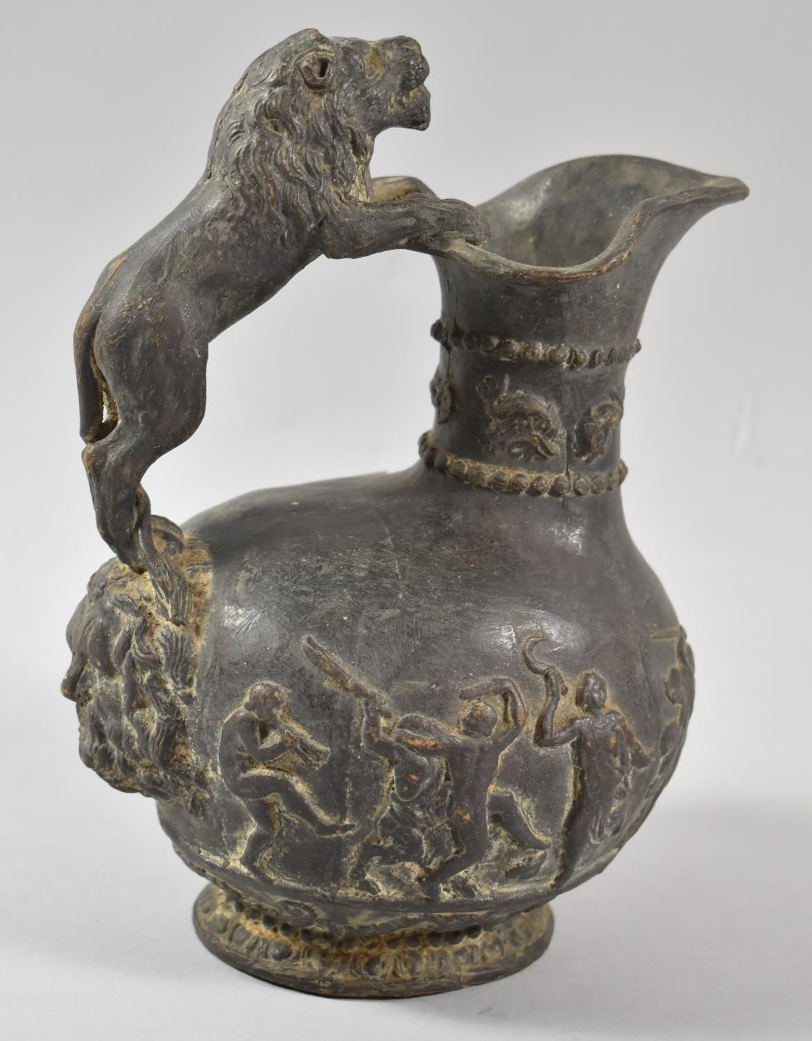 A 19th Century Basalt Effect Plaster Wine Jug, the Body Decorated in Relief with Dancing Figures and