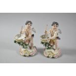 A Pair of Continental Figural Ornaments in the Form of Cupids with Bows, 12.5cm high