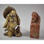 A Carved Soapstone Paperweight in the Form of Plinth with Seated Ram Together with a Carved