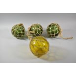 A Collection of Four Hand Blown Glass Fishing Floats, Green Examples, 12.5cm Diameter