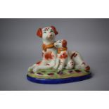 A Reproduction Staffordshire Group, Dog and Pup, 21cm long