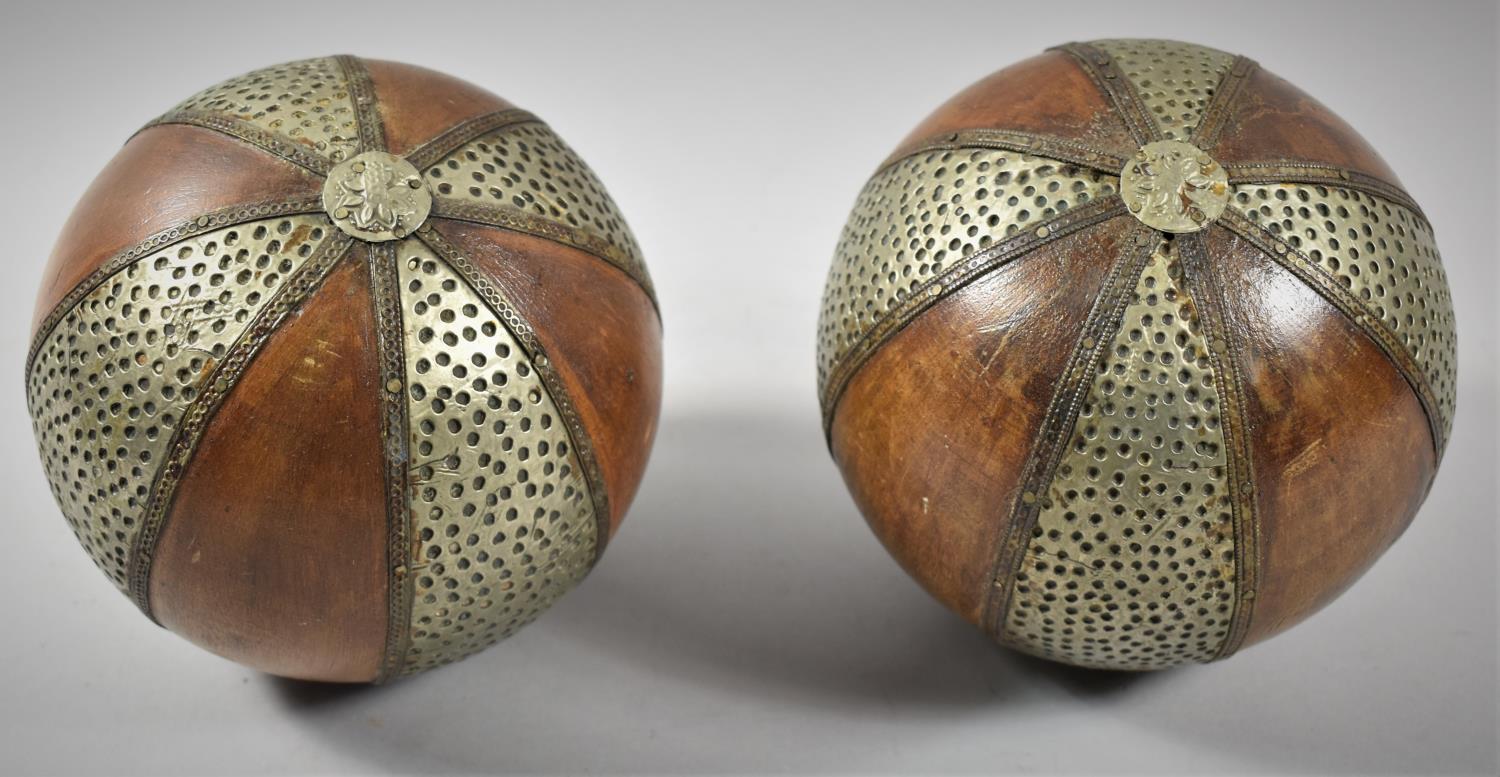 A Pair of Far Eastern Metal Mounted Wooden Balls, 14.5cm Diameter