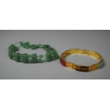 A Jadeite Bracelet and Oriental Gilt Metal and Polished Stone Bracelet