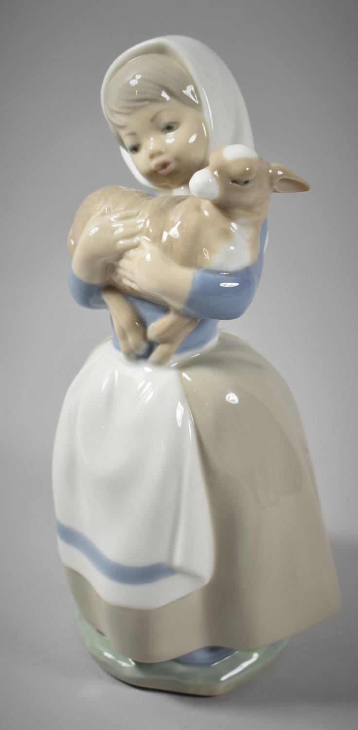 A Spanish Nao Figure of Girl with Lamb, 21cm high