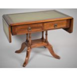 A Reproduction Mahogany Drop Leaf Coffee Table in the Form of a Sofa Table with Tooled Leather Top
