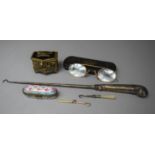 A Long Silver Handled Pistol Grip Button Hook and Two Mother of Pearl Handled Miniature Examples,