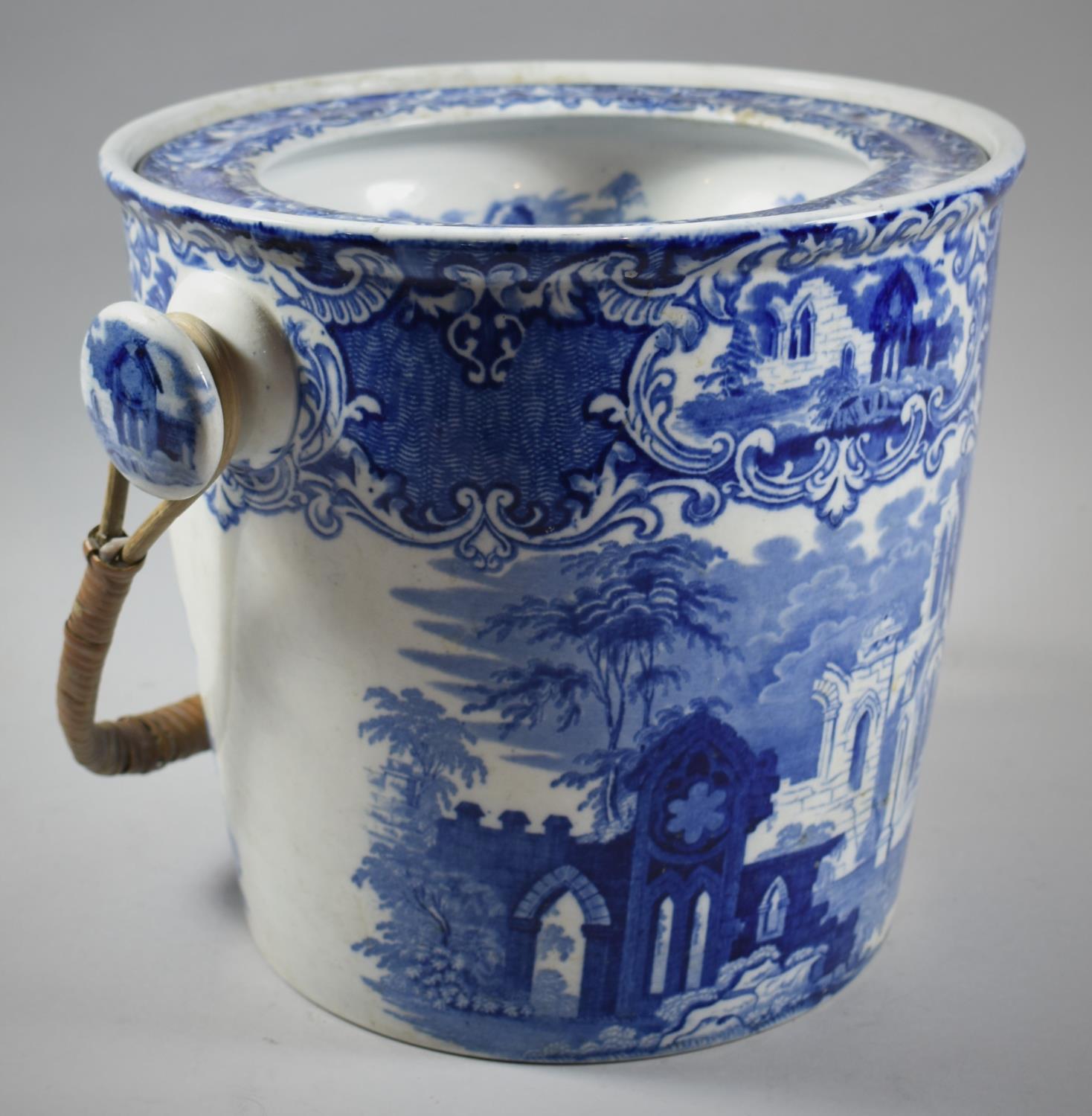 A Transfer Printed Blue and White Toiletry Pail with Cane Loop Handle, 25cm high, Chip to Base